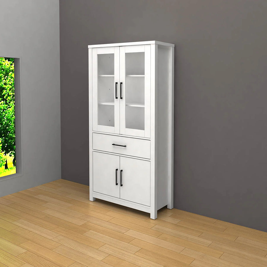 Tall white cabinet with glass upper doors and solid lower doors stands against a gray wall, next to a window showing greenery. Modern and minimalist.