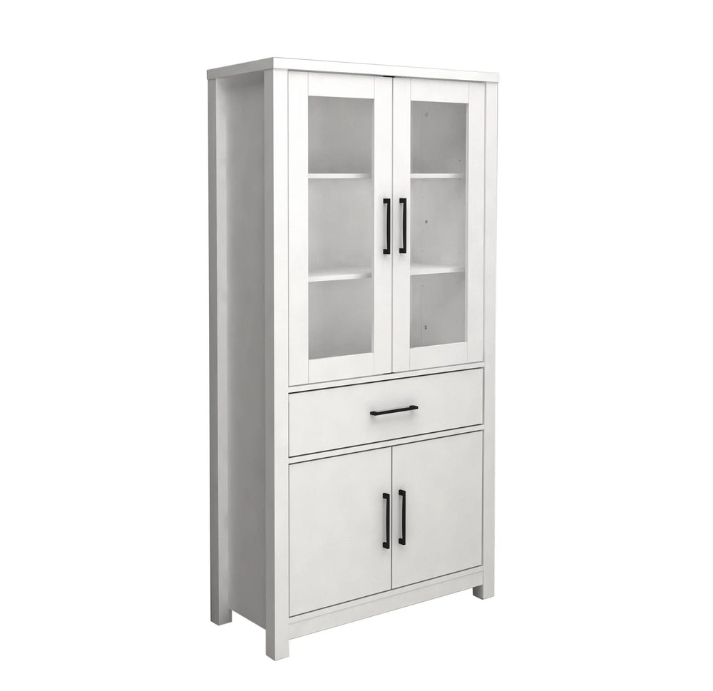 White pantry cabinet with a tall design, featuring two upper glass doors, a central drawer, and two lower solid doors, all with black handles.