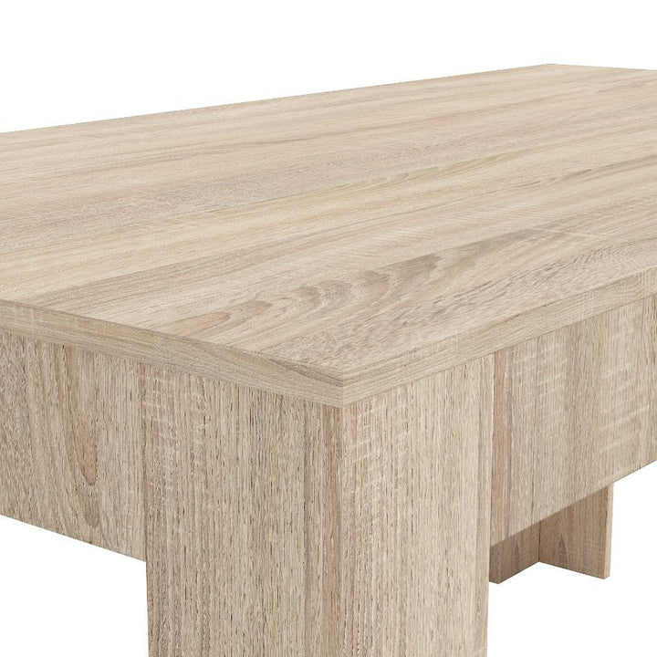 Close-up view of a light wood table, showcasing a smooth, rectangular surface and subtle grain patterns, conveying a modern and minimalist style.