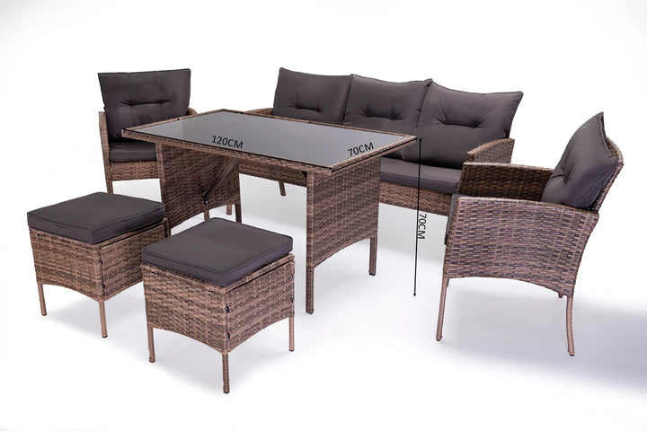 Conjunto de jardín de mimbre compuesto por una mesa con tablero de cristal, dos sillas con cojines, un sofá de tres plazas y dos pufs. Las dimensiones en centímetros figuran en la tabla.