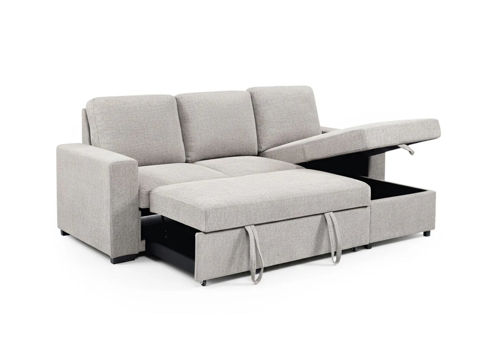 Un sofá modular moderno de color beige que incluye una chaise longue y un cajón extraíble con espacio de almacenamiento. El mueble destaca por su funcionalidad y su diseño minimalista.
