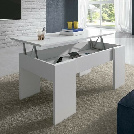 Mesa de centro moderna de color blanco con una superficie elevada que deja al descubierto un espacio de almacenamiento. Sobre ella descansan objetos como libros y vasos, en una estancia luminosa y minimalista.